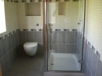 Double shower tray and glass enclosure with wall hung wc and consealed cistern with push flush